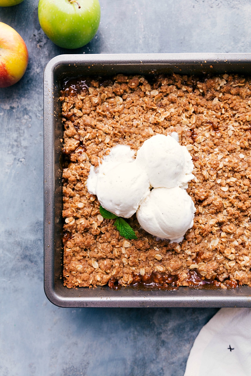Overhead image of Apple Crumble, fresh out of the oven, with ice cream on top.