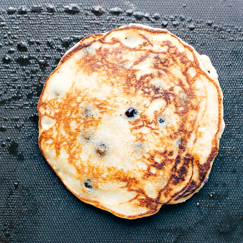 Image of the cooked best blueberry pancake recipe on the griddle still