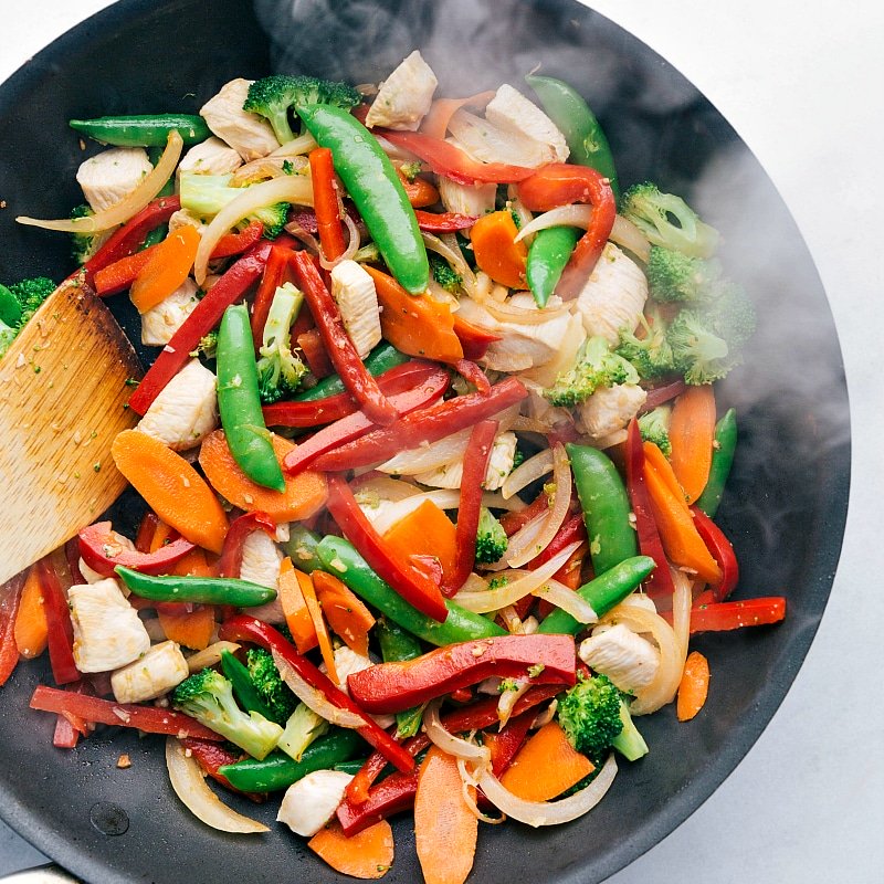 Image of the fresh vegetables and chicken being mixed together for this Chicken Stir Fry.