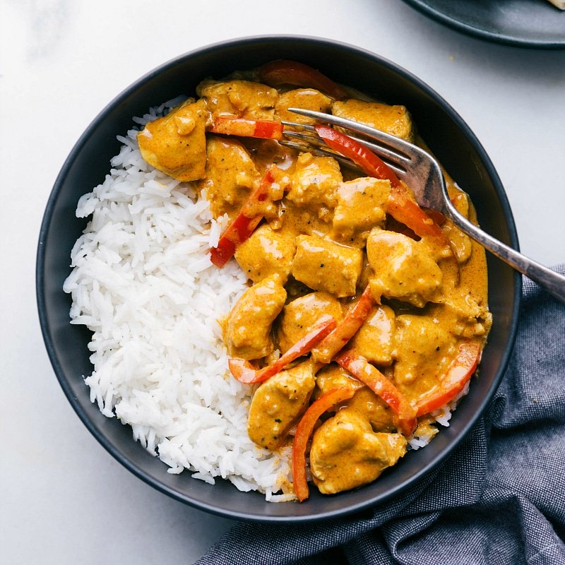 Image of Coconut Curry Chicken on a bed of rice, ready to eat.