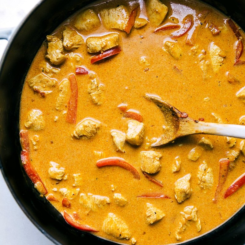 Image of Coconut Curry Chicken in the pan with lots of sauce.