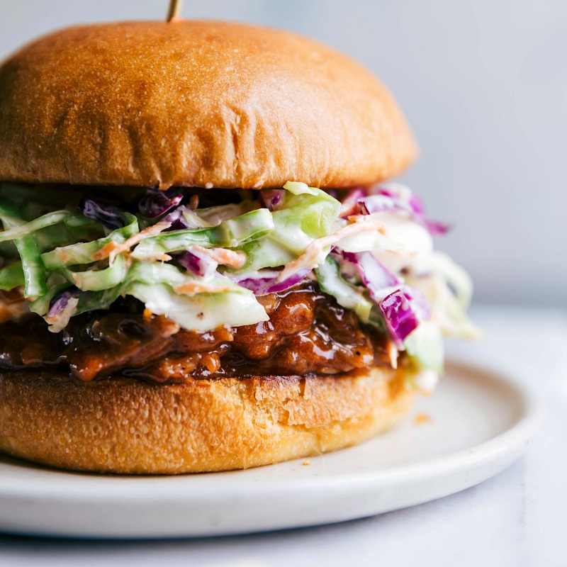 Up-close image of Crockpot BBQ Pulled Pork sandwich showing off the pork and coleslaw layers.