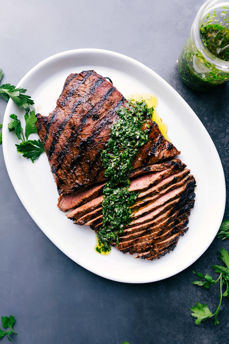 Overhead image of the Grilled Flank Steak with chimichurri sauce over it