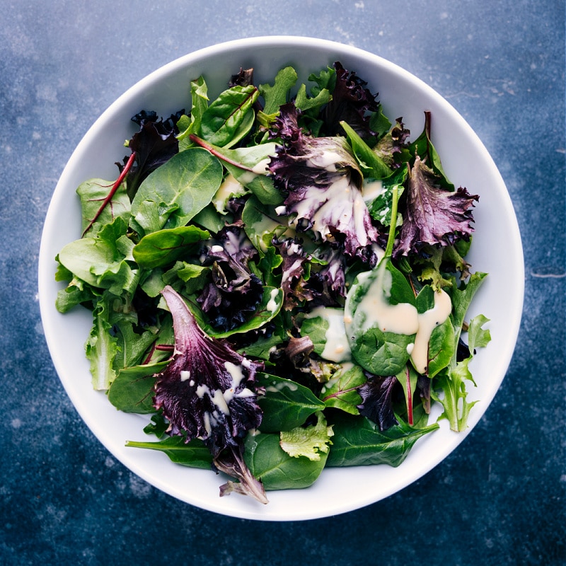 Overhead view of a mixed greens salad with Honey Mustard Vinaigrette dressing